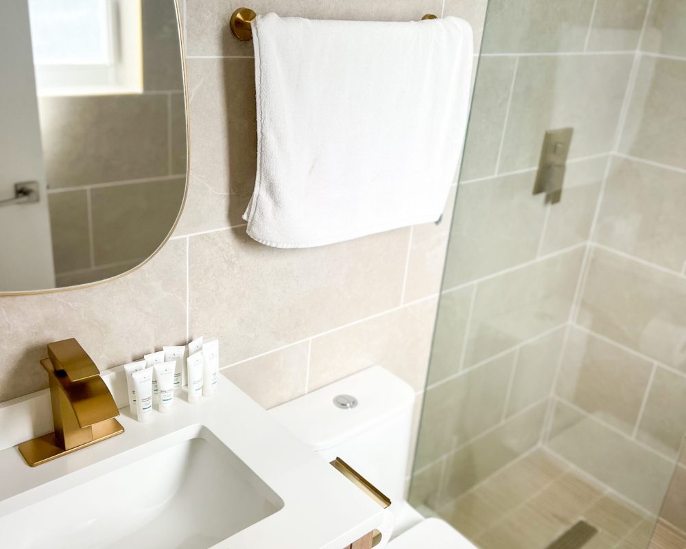 Updated bathroom interior at Tiana Beach Inn with glass shower and modern finishes