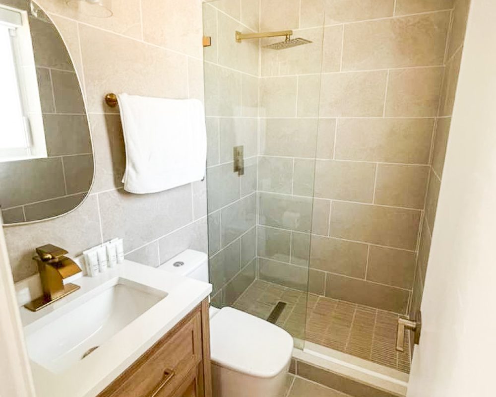 Bathroom with walk-in shower and modern vanity at Tiana Beach Inn Hollywood Beach