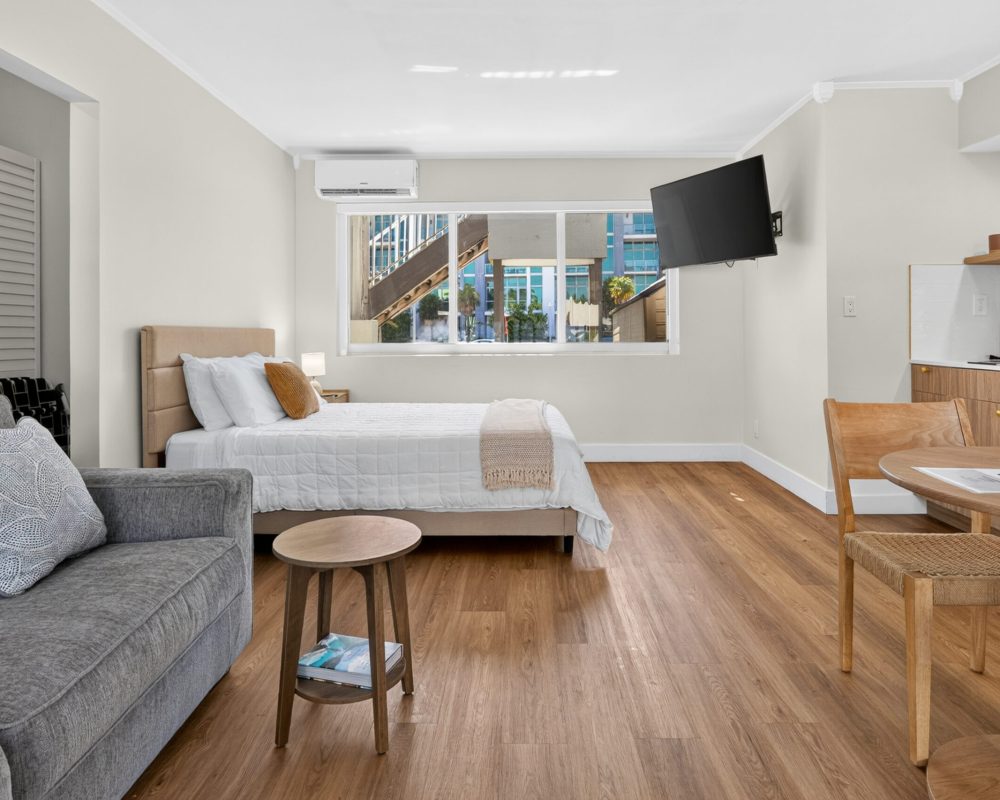 Spacious Deluxe Quadruple Room with queen bed and sofa at Tiana Beach Inn