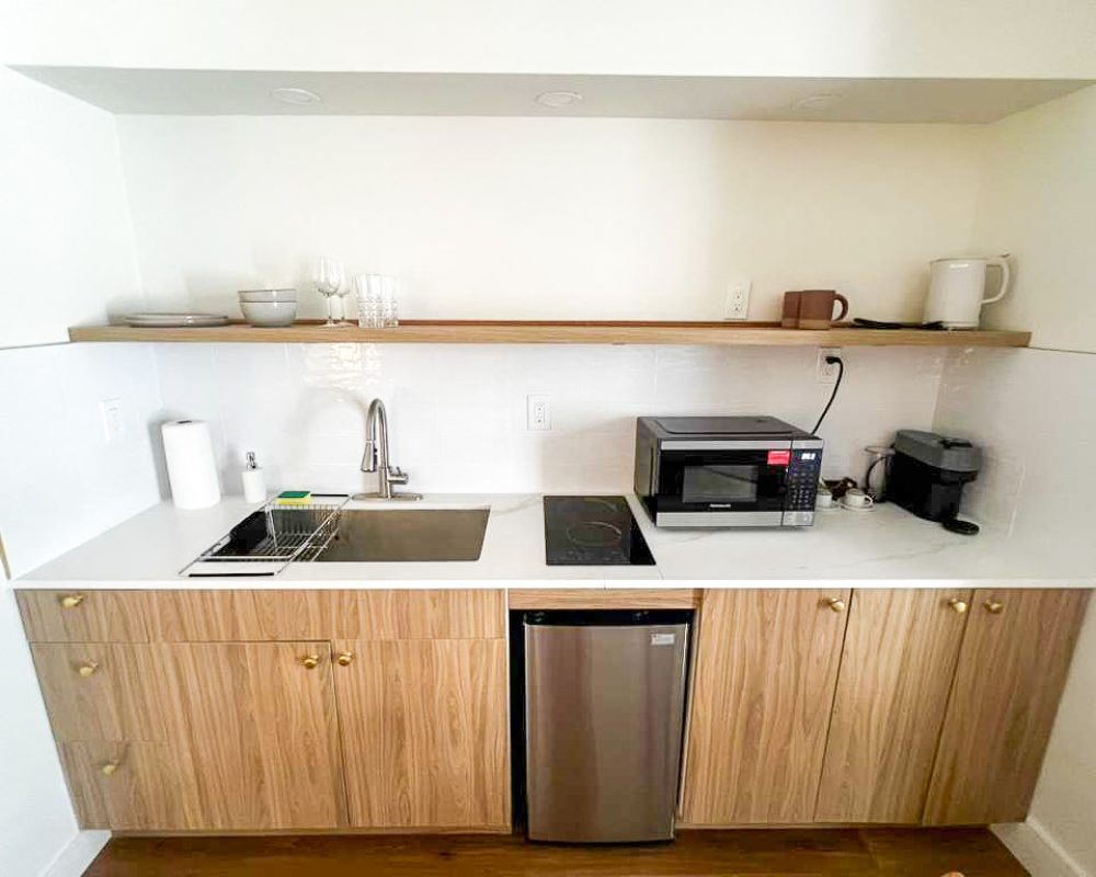 Bright Deluxe Room at Tiana Beach Inn with seating area and kitchenette near Hollywood Beach Broadwalk