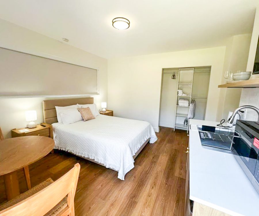 Standard Room interior with mini kitchenette and storage space at Tiana Beach Inn Florida